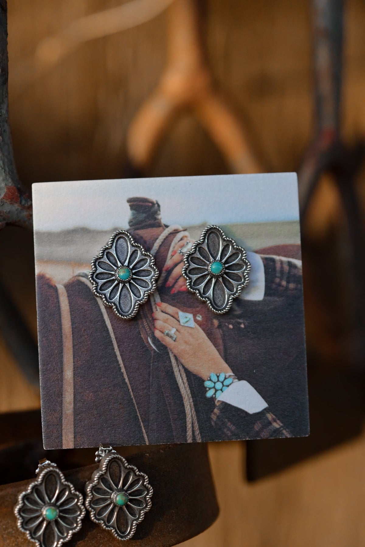 ouble M Beadwork silver and turquoise Western stud earrings displayed with a vintage cowgirl photo